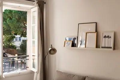 a living room with a window and a couch at 3P Central Cannes Suquet in Cannes