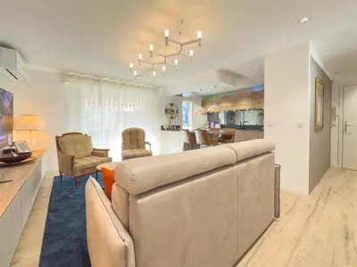 a living room with a couch and a dining room at Le Marcellin by Winsome Destination in Cannes