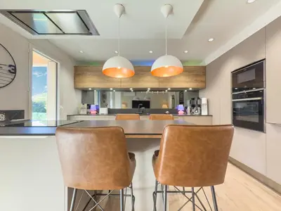 a kitchen with a large island with bar stools at Le Marcellin by Winsome Destination in Cannes