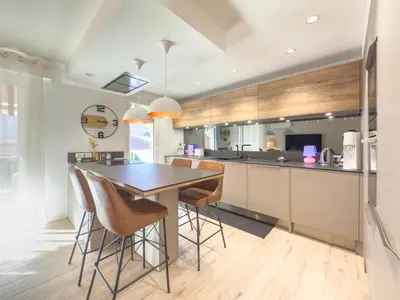 a kitchen with a table and bar stools at Le Marcellin by Winsome Destination in Cannes