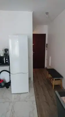 a room with a white refrigerator and a door at Cannes proche croisette in Cannes