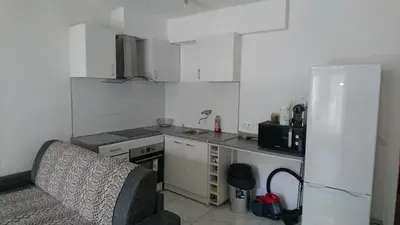 a small kitchen with a refrigerator and a sink at Cannes proche croisette in Cannes