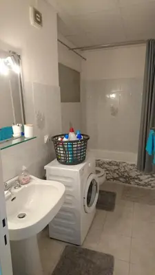 a bathroom with a sink and a washing machine at Cannes proche croisette in Cannes