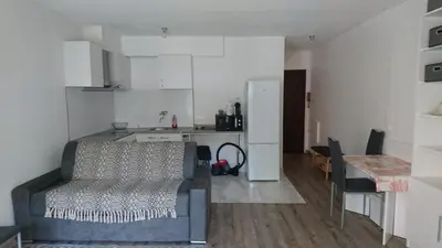 a living room with a couch and a kitchen at Cannes proche croisette in Cannes