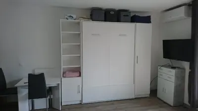 a white room with a desk and a large white cabinet at Cannes proche croisette in Cannes