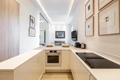 a kitchen with white cabinets and a counter top at REF 1975 - Cannes Center - Croisette in Cannes