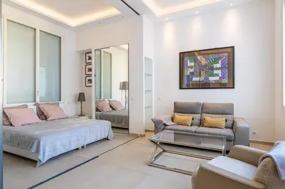a living room with a bed and a couch at REF 1975 - Cannes Center - Croisette in Cannes