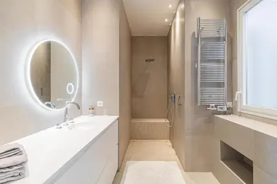 a white bathroom with a sink and a mirror at REF 1975 - Cannes Center - Croisette in Cannes
