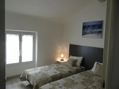 two beds in a white room with two windows at Day's Inn Cannes in Cannes