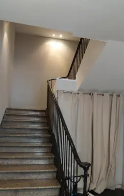 a staircase in a house with a curtain at Day's Inn Cannes in Cannes