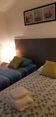 two beds in a hotel room with towels on them at Day's Inn Cannes in Cannes