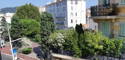 a view of a city with trees and buildings at Day's Inn Cannes in Cannes