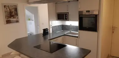 a kitchen with a sink and a counter top at Day's Inn Cannes in Cannes