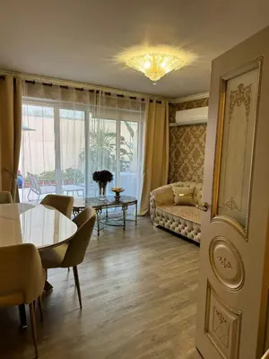 a living room with a table and a couch at Le Chevreuse Cannes centre-ville in Cannes