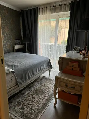 a bedroom with a bed and a dresser and a window at Le Chevreuse Cannes centre-ville in Cannes