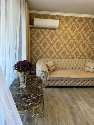 a living room with a couch and a table at Le Chevreuse Cannes centre-ville in Cannes