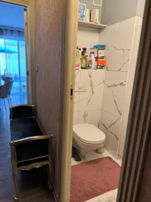 a bathroom with a toilet and a stool in it at Le Chevreuse Cannes centre-ville in Cannes