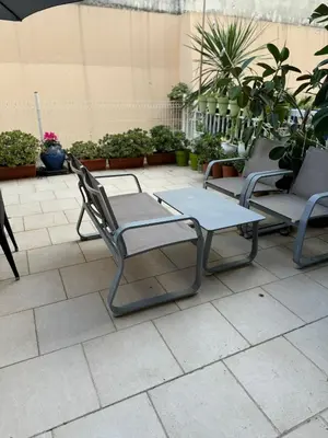 a group of chairs and a table on a patio at Le Chevreuse Cannes centre-ville in Cannes