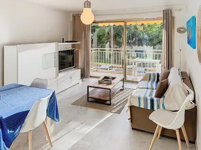 a living room with a couch and a table at Bel appartement à 2 pas des plages 151L DEBL in Cannes