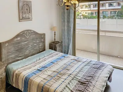 a bedroom with a bed and a large window at Bel appartement à 2 pas des plages 151L DEBL in Cannes