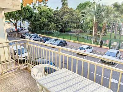 a balcony with a bench and cars parked on a street at Bel appartement à 2 pas des plages 151L DEBL in Cannes
