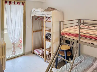 a dorm room with bunk beds and a ladder at Bel appartement à 2 pas des plages 151L DEBL in Cannes