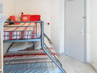 a bedroom with a bunk bed with a ladder at Bel appartement à 2 pas des plages 151L DEBL in Cannes