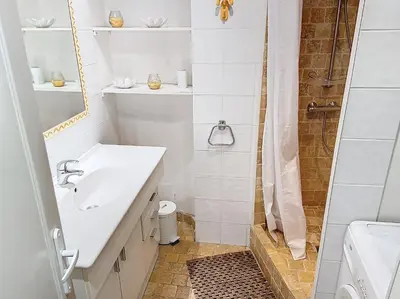 a white bathroom with a sink and a shower at Bel appartement à 2 pas des plages 151L DEBL in Cannes