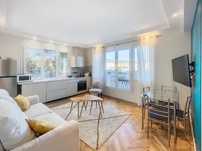a living room with a white couch and a table at 3p Quai St Pierre - 348L Alexa in Cannes