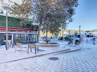 a park with a fountain and chairs on a street at 3p Quai St Pierre - 348L Alexa in Cannes