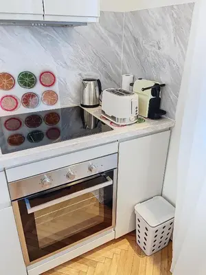 a kitchen with a counter top with a stove top oven at 3p Quai St Pierre - 348L Alexa in Cannes