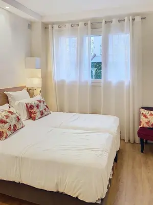 a bedroom with a large white bed and a window at 3p Quai St Pierre - 348L Alexa in Cannes