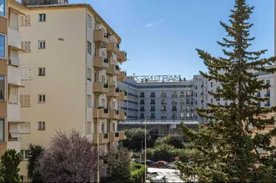 a tall building with a christmas tree in front of it at Joli 2 pcs - Prox Martinez in Cannes