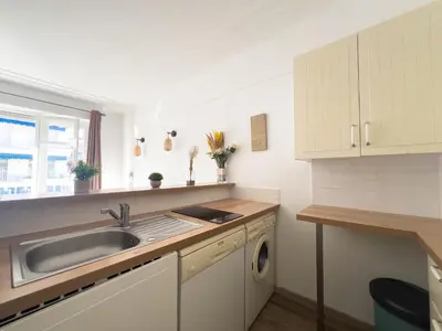 a kitchen with a sink and a dishwasher at Calme et centrale avec balcon ensoleillé in Le Cannet