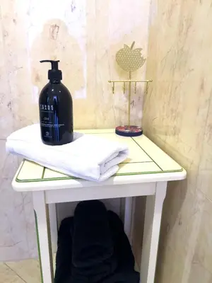 a white table with a bottle of soap on it at Calme et centrale avec balcon ensoleillé in Le Cannet