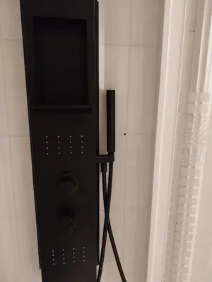 a black speaker in the corner of a bathroom at Palm beach Cannes La Brise in Cannes