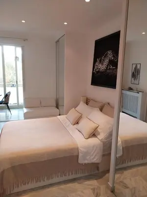 a bedroom with a large bed in a room at Palm beach Cannes La Brise in Cannes