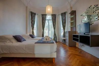 a bedroom with a large bed and a flat screen tv at Appartement Vaste Horizon - LRA Cannes in Cannes
