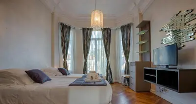 a bedroom with a large bed and a television at Appartement Vaste Horizon - LRA Cannes in Cannes