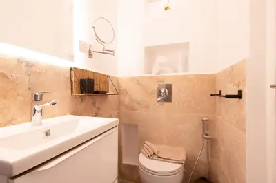a bathroom with a white sink and a toilet at cœur historique de cannes entre palais et mer in Cannes