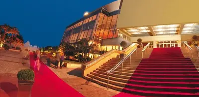 a building with a red carpeted staircase in front of a building at cœur historique de cannes entre palais et mer in Cannes