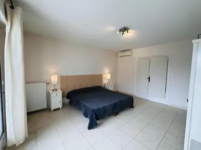 a bedroom with a bed and two lights on the ceiling at Two bedroom apartment on a high floor in the center of Cannes a few steps from the Croisette beaches - 2229 in Cannes