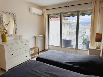 a bedroom with a bed and a dresser and a window at Two bedroom apartment on a high floor in the center of Cannes a few steps from the Croisette beaches - 2229 in Cannes