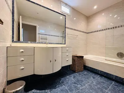 a bathroom with a sink and a tub and a mirror at Two bedroom apartment on a high floor in the center of Cannes a few steps from the Croisette beaches - 2229 in Cannes