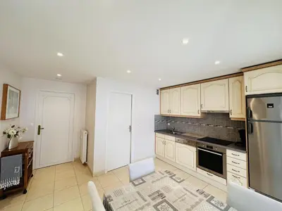a kitchen with white cabinets and stainless steel appliances at Two bedroom apartment on a high floor in the center of Cannes a few steps from the Croisette beaches - 2229 in Cannes