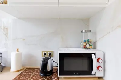 a microwave oven sitting on top of a kitchen counter at Carlton area superb 1 bedroom in Cannes
