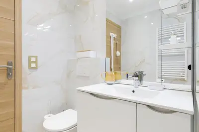 a white bathroom with a sink and a toilet at Carlton area superb 1 bedroom in Cannes