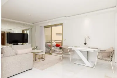 a living room with a couch and a table at Carlton area superb 1 bedroom in Cannes
