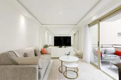 a living room with a couch and a table at Carlton area superb 1 bedroom in Cannes