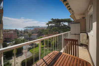a table with chairs and a view of the ocean at FRGK Fauvettes Apartment Terrace, Parking, AC & Ultra-Fast Wi-Fi in Cannes